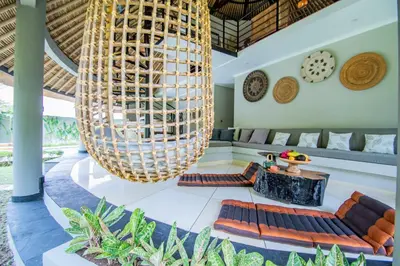 a large chandelier hangs in the lobby of a resort at SuB Villas Bali in Canggu