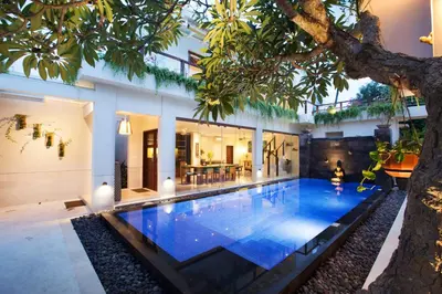a swimming pool in the middle of a house at Sunset Paradise Jimbaran 3003 in Jimbaran