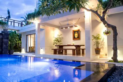 a villa with a swimming pool and a dining room at Sunset Paradise Jimbaran 3003 in Jimbaran