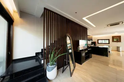a living room with a plant on the wall at Mokko Suite Villas Umalas Bali in Seminyak