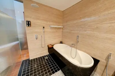 a bathroom with a bath tub and a shower at Mokko Suite Villas Umalas Bali in Seminyak