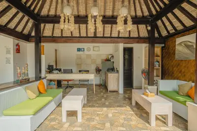 a living room with two couches and a table at The Tukad Villa in Seminyak