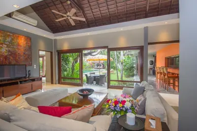 a living room with a couch and a table at Chimera Villas in Seminyak
