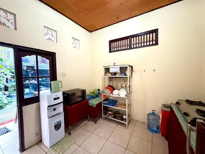 a kitchen with a small refrigerator and a counter at Dwiputra Guest House in Canggu