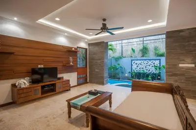 a living room with a couch and a tv at Villa Suzuki 1 Seminyak in Seminyak