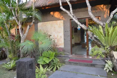 a house with a glass door and some plants at The Buah Bali Villas in Seminyak