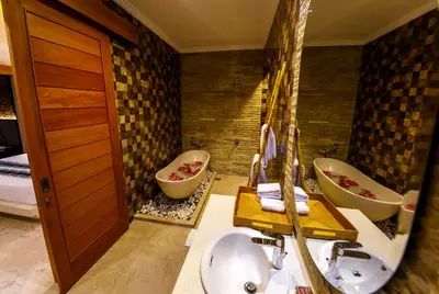 a bathroom with two sinks and two toilets at Villa Suzuki 2 Seminyak in Seminyak
