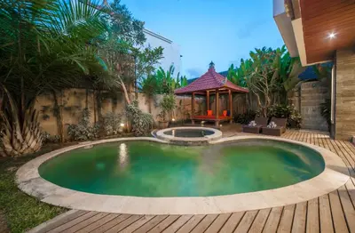 a small pool in a backyard with a gazebo at Villa Suzuki 2 Seminyak in Seminyak