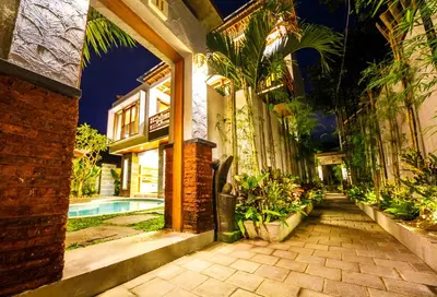 a courtyard of a building with a swimming pool at Villa Suzuki 2 Seminyak in Seminyak