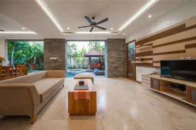 a living room with a couch and a flat screen tv at Villa Suzuki 2 Seminyak in Seminyak