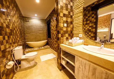 a bathroom with a toilet and a sink and a tub at Villa Suzuki 3 Seminyak in Seminyak