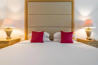 a bedroom with a large white bed with red pillows at Bintang Bali Resort in Kuta