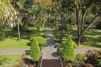 an aerial view of a park with trees and bushes at Bintang Bali Resort in Kuta