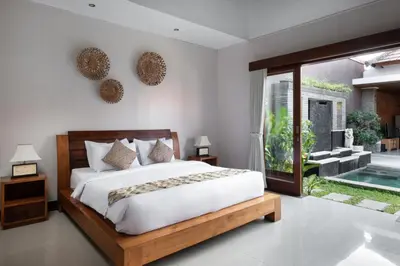 a bedroom with a bed and a sliding glass door at Villa Lapiz Lazuli Seminyak Kuta in Seminyak