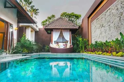 a swimming pool with a gazebo next to a house at Villa Lapiz Lazuli Seminyak Kuta in Seminyak