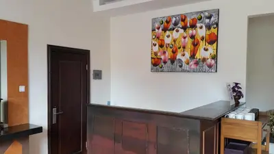 a room with a painting of chickens on the wall at Guest House Matahari in Kuta