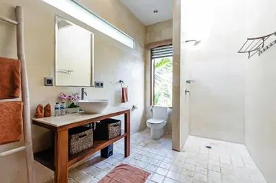 a bathroom with a sink and a toilet at Villa Mienna in Seminyak