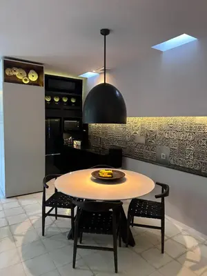 a kitchen with a table and chairs in a room at Villa 80361 in Seminyak
