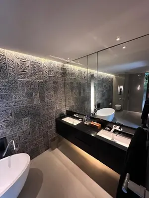 a bathroom with two sinks and a tub and a toilet at Villa 80361 in Seminyak