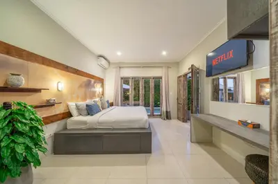 a large bedroom with a bed in the middle at Villa Sarong 1 in Seminyak