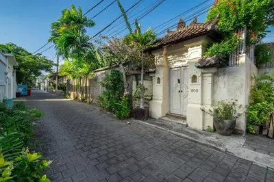 a cobblestone street in an alley with houses at Villa Sarong 1 in Seminyak
