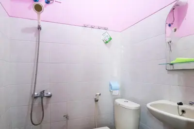 a bathroom with a shower and a toilet and a sink at Anantaya Home Denpasar in Denpasar