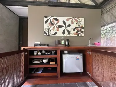 a kitchen with a counter with a sink and a dishwasher at Komea Villa in Canggu