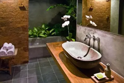 a bathroom with a large bowl sink on a wooden counter at Komea Villa in Canggu