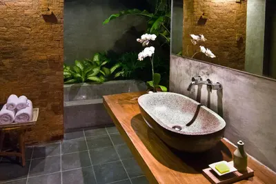 a bathroom with a large sink in a room at Komea Villa in Canggu