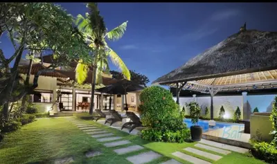 a villa with a swimming pool and a resort at Villa Seminyak William in Seminyak