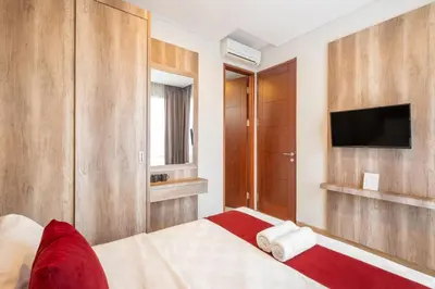a bedroom with a bed with a flat screen tv at Cove Villa Prana in Jimbaran