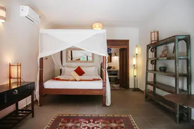 a bedroom with a bed with a canopy at Villa Hangat in Seminyak