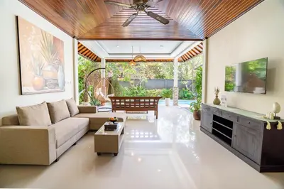 a living room with a couch and a table at Gracia Bali Villas & Apartment Managed by Manara in Seminyak