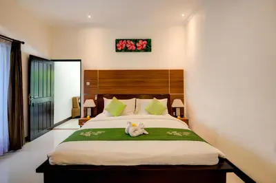 a bedroom with a bed with a stuffed animal on it at Gracia Bali Villas & Apartment Managed by Manara in Seminyak