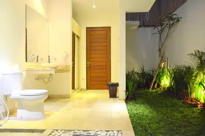 a bathroom with a toilet and a sink at The Jas Villas in Seminyak