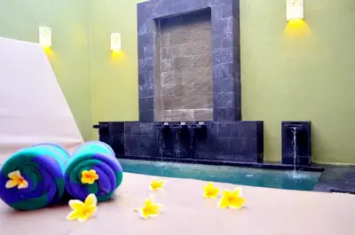 a pool with blue beach balls and flowers on the floor at The Jas Villas in Seminyak