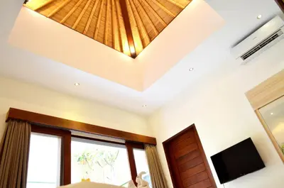 a room with a ceiling with a chandelier at The Jas Villas in Seminyak