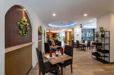 a dining room with a table and chairs at Everyday Hotel Kuta Central in Kuta
