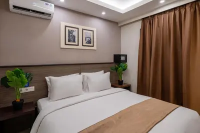 a bedroom with a large bed with white pillows at Everyday Hotel Kuta Central in Kuta