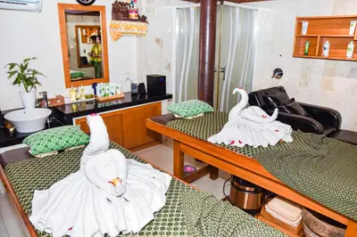 two swans are sitting on beds in a room at The Lokha Legian Resort & Spa in Legian