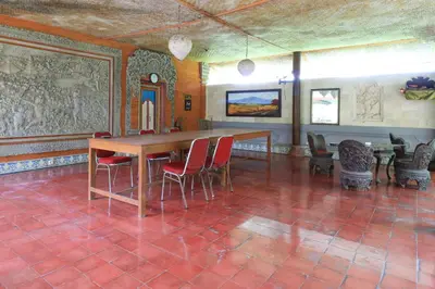a dining room with a table and chairs at Mertha Jati Hotel in Kuta