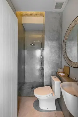 a bathroom with a toilet and a sink and a shower at Casamaya Villa in Legian