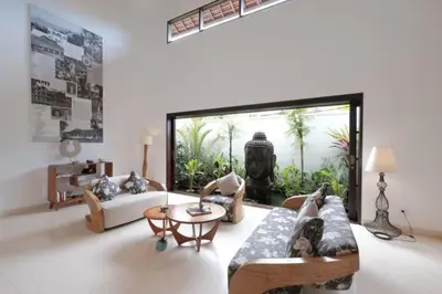 a living room with a couch and a table at Villa Eva in Seminyak