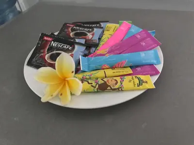 a plate with a flower and other items on it at Kuta Regency B10 One Bedroom Villa in Kuta