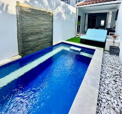 a swimming pool in the backyard of a house at Kuta Regency B10 One Bedroom Villa in Kuta
