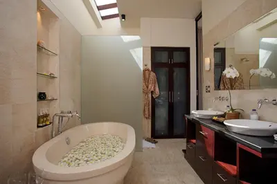 a bathroom with a large tub and two sinks at Temple Hill Residence Villa in Jimbaran