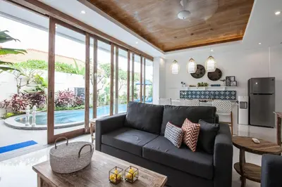 a living room with a couch and a table at Ambermoon Villa 2 in Seminyak