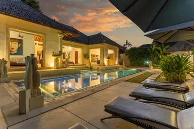 a villa with a swimming pool and a house at Villa Dewata 3 in Seminyak