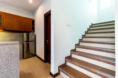 a kitchen and a staircase in a house at Villa Chandraika - 3BR Private Pool Villa by AGATA in Seminyak