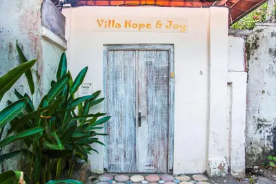 a door with a sign that reads wildlife hope and joy at Villa Coconut Bali in Seminyak